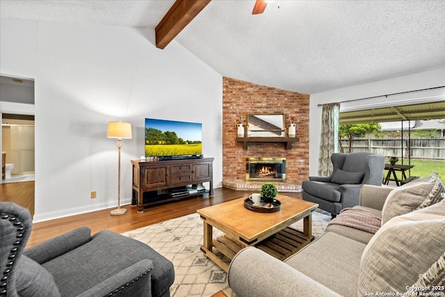 3527 Oakhorne St, San Antonio, TX 78247 - living area with wood finished floors, a ceiling fan, a brick fireplace, and a textured ceiling