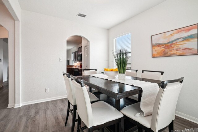 6123 Foster Ml, San Antonio, TX 78222 - dining room with arched walkways and wood finished floors