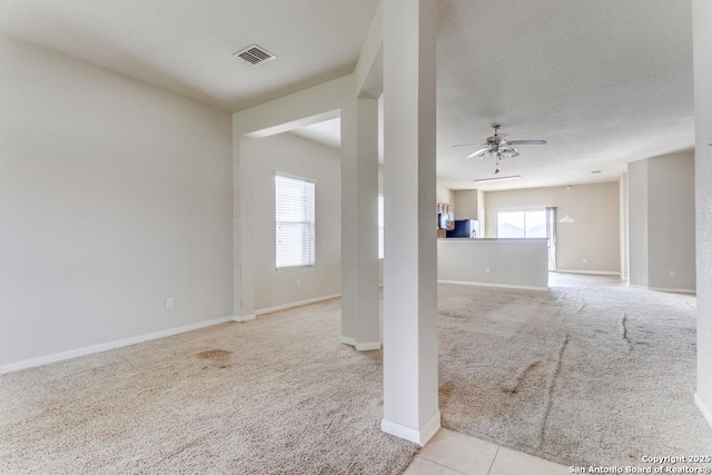 4310 Loring, Converse, TX 78109 - unfurnished living room featuring light colored carpet and a ceiling fan