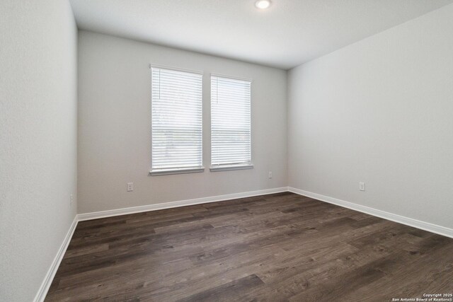 1619 Vista View Dr, Pleasanton, TX 78064 - spare room featuring dark wood-style flooring and baseboards