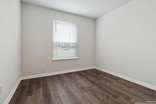 1619 Vista View Dr, Pleasanton, TX 78064 - spare room featuring dark wood-type flooring and baseboards