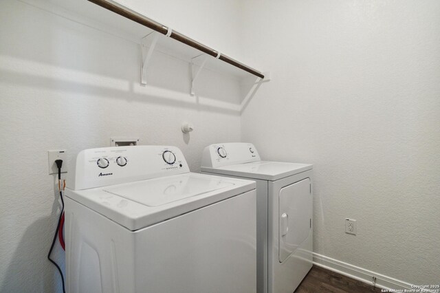 1619 Vista View Dr, Pleasanton, TX 78064 - laundry room featuring washer and clothes dryer, dark wood-style flooring, and a textured wall