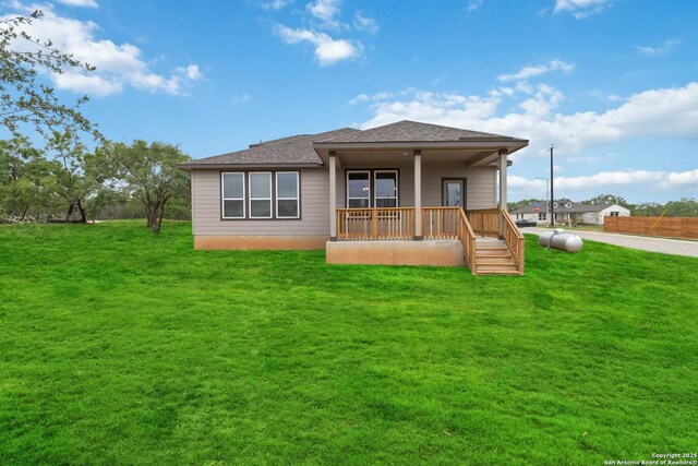 1619 Vista View Dr, Pleasanton, TX 78064 - back of house with a lawn, a shingled roof, and a porch