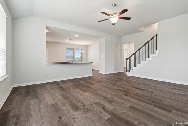 1619 Vista View Dr, Pleasanton, TX 78064 - unfurnished living room with dark wood-style flooring, a ceiling fan, and stairway