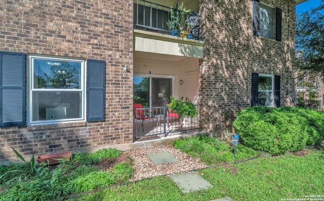 1819 Babcock Unit 605, San Antonio, TX 78229 - view of exterior entry featuring brick siding, a patio, and a balcony