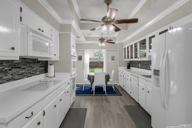 1819 Babcock Unit 605, San Antonio, TX 78229 - kitchen featuring white appliances, light wood finished floors, tasteful backsplash, white cabinetry, and light countertops