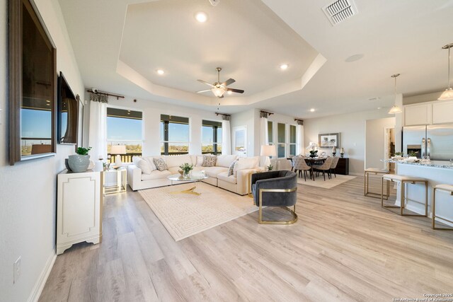 1562 Vista View Dr, Pleasanton, TX 78064 - living area with a tray ceiling, ceiling fan, light wood-style flooring, and recessed lighting