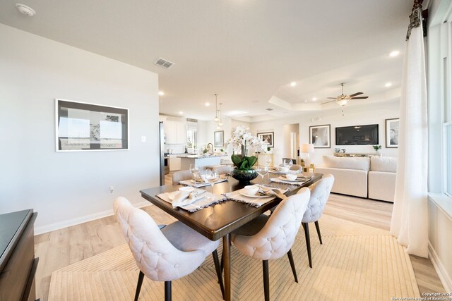 1562 Vista View Dr, Pleasanton, TX 78064 - dining room featuring light wood-style floors, recessed lighting, a ceiling fan, and a raised ceiling