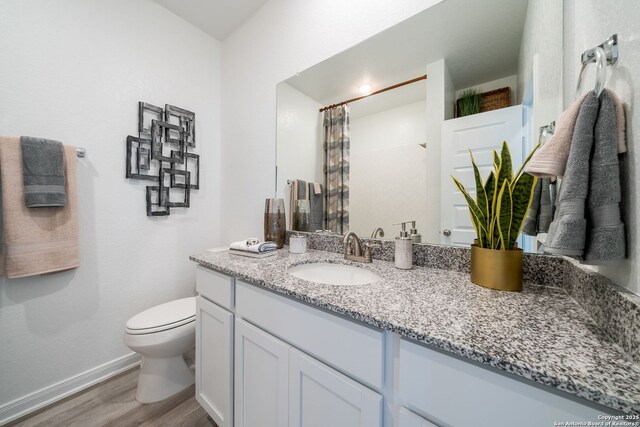 1562 Vista View Dr, Pleasanton, TX 78064 - bathroom with vanity, wood finished floors, and a shower with curtain