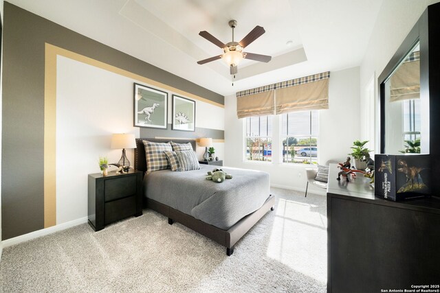 1562 Vista View Dr, Pleasanton, TX 78064 - bedroom with a raised ceiling, light carpet, and a ceiling fan