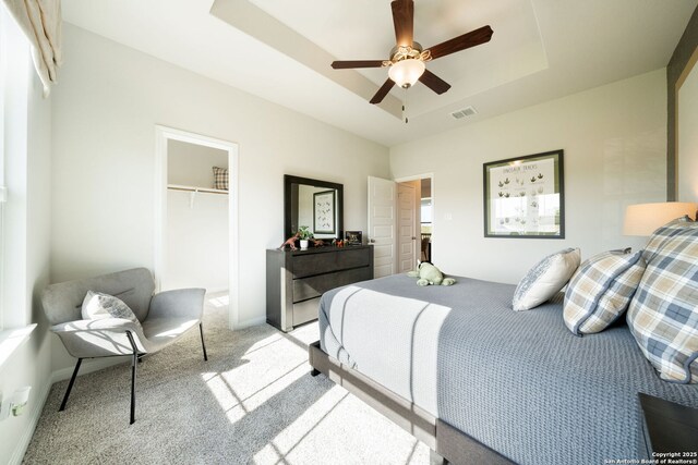 1562 Vista View Dr, Pleasanton, TX 78064 - bedroom featuring light carpet, a tray ceiling, a spacious closet, a closet, and ceiling fan
