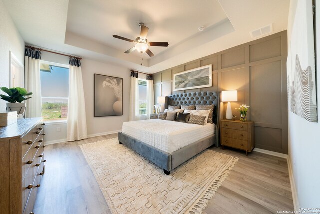 1562 Vista View Dr, Pleasanton, TX 78064 - bedroom with a raised ceiling, light wood-style floors, and ceiling fan
