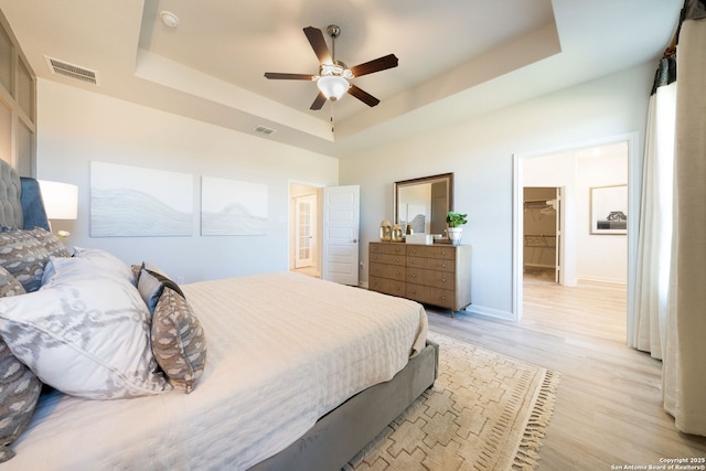 1562 Vista View Dr, Pleasanton, TX 78064 - bedroom featuring a tray ceiling, light wood-type flooring, and a ceiling fan