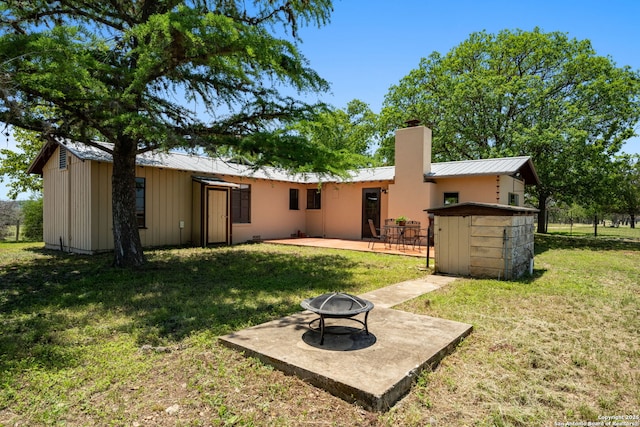 13132 State Highway 16, Medina, TX 78055 - rear view of property with a fire pit, a patio, a metal roof, a lawn, and a chimney