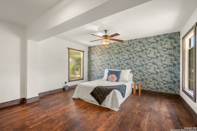 13132 State Highway 16, Medina, TX 78055 - bedroom with wallpapered walls, wood finished floors, an accent wall, and ceiling fan