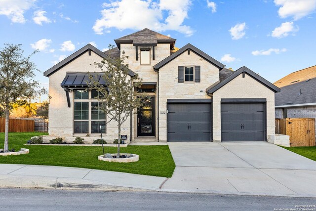 2604 Sueno Pt, San Antonio, TX 78245 - french provincial home with concrete driveway, stone siding, a standing seam roof, and an attached garage