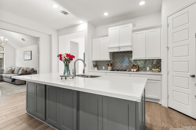 2604 Sueno Pt, San Antonio, TX 78245 - kitchen with light countertops, white cabinets, decorative backsplash, gray cabinets, and recessed lighting