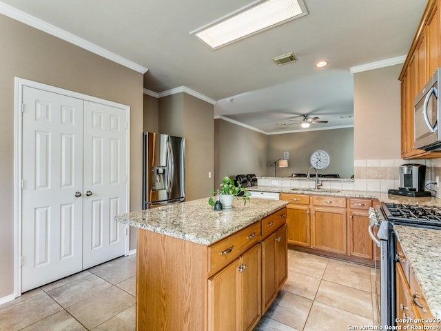 2115 Encino Breeze, San Antonio, TX 78259 - kitchen with stainless steel appliances, ornamental molding, a kitchen island, light tile patterned floors, and ceiling fan