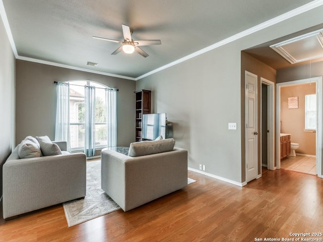 2115 Encino Breeze, San Antonio, TX 78259 - living area with attic access, plenty of natural light, ceiling fan, wood finished floors, and ornamental molding