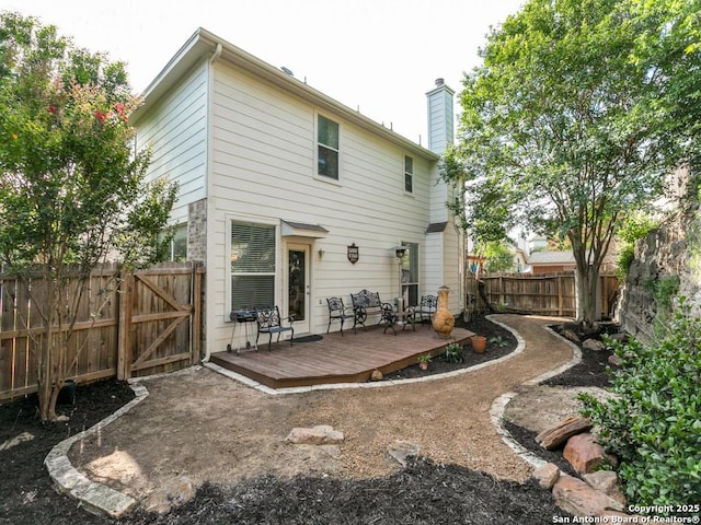 2115 Encino Breeze, San Antonio, TX 78259 - back of property with a deck, a fenced backyard, a chimney, and a gate