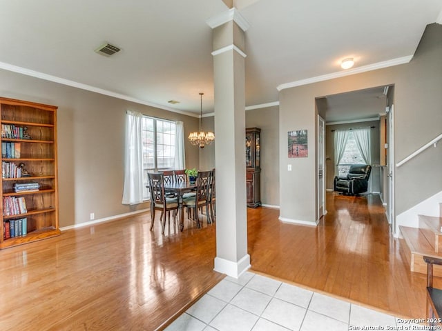 2115 Encino Breeze, San Antonio, TX 78259 - dining space featuring light wood finished floors, healthy amount of natural light, crown molding, a chandelier, and stairs