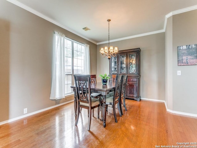 2115 Encino Breeze, San Antonio, TX 78259 - dining space with a chandelier, light wood-type flooring, and ornamental molding