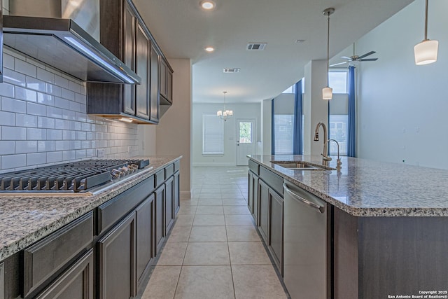 12455 Diagon Aly, San Antonio, TX 78254 - kitchen featuring wall chimney range hood, appliances with stainless steel finishes, backsplash, dark brown cabinetry, and recessed lighting
