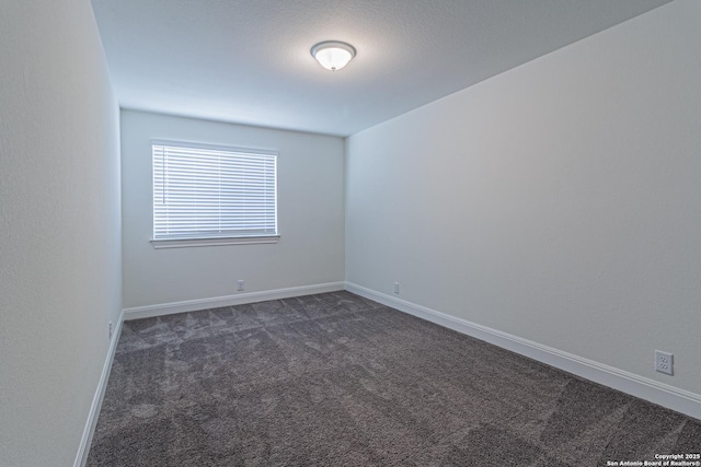 12455 Diagon Aly, San Antonio, TX 78254 - spare room featuring dark colored carpet and baseboards