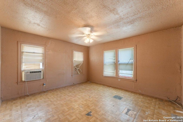 518 Wright Ave, Schertz, TX 78154 - unfurnished room featuring cooling unit, plenty of natural light, a ceiling fan, and a textured ceiling