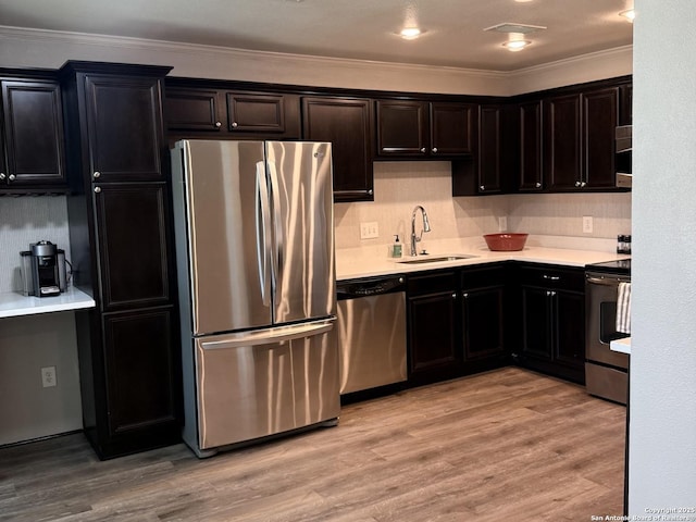 100 Lorenz Rd Unit 803, San Antonio, TX 78209 - kitchen with stainless steel appliances, ornamental molding, light countertops, light wood-style flooring, and tasteful backsplash