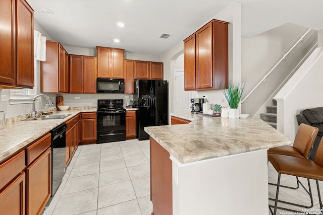 2059 Wind Chime, New Braunfels, TX 78130 - kitchen featuring black appliances, a peninsula, a breakfast bar area, recessed lighting, and light tile patterned floors