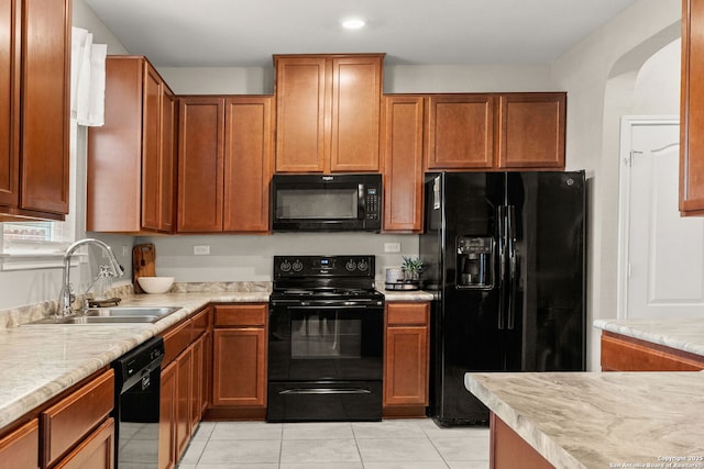 2059 Wind Chime, New Braunfels, TX 78130 - kitchen featuring black appliances, light countertops, light tile patterned flooring, brown cabinets, and recessed lighting