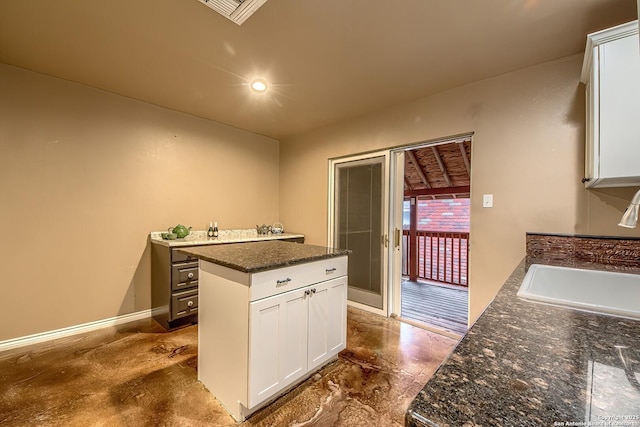4326 Hilton Head, San Antonio, TX 78217 - kitchen with white cabinetry, dark stone countertops, and a kitchen island