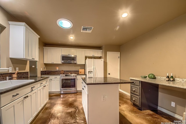 4326 Hilton Head, San Antonio, TX 78217 - kitchen featuring appliances with stainless steel finishes, white cabinets, a center island, finished concrete flooring, and recessed lighting