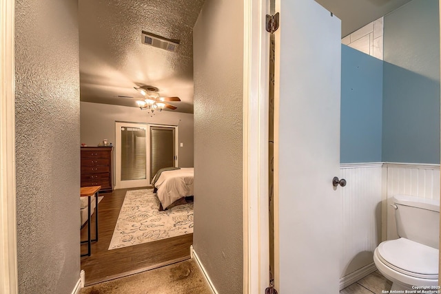 4326 Hilton Head, San Antonio, TX 78217 - bathroom featuring a ceiling fan, wainscoting, a textured wall, and wood finished floors