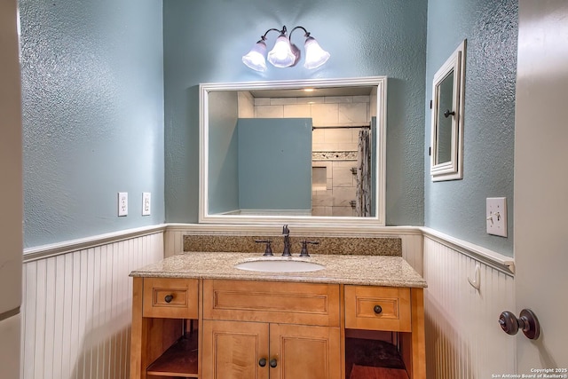 4326 Hilton Head, San Antonio, TX 78217 - bathroom featuring wainscoting, vanity, a chandelier, a textured wall, and curtained shower