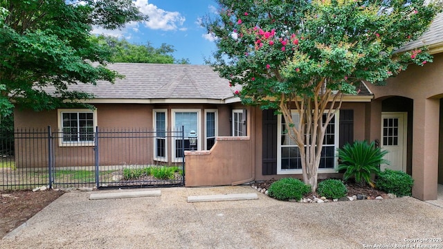 5 Remington, San Antonio, TX 78258 - view of front of property with stucco siding and a shingled roof