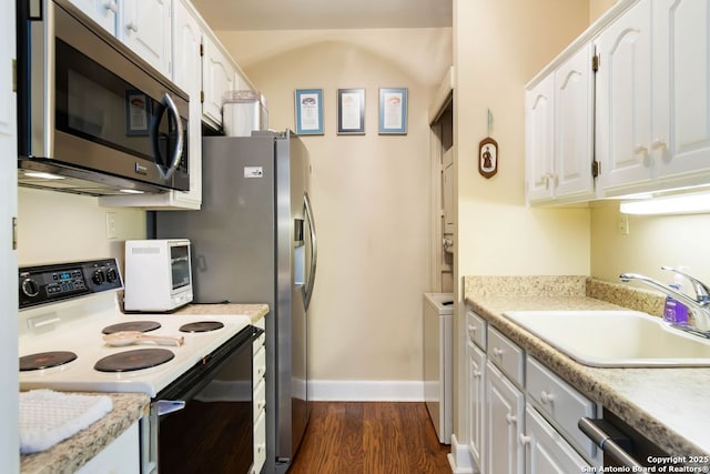 5 Remington, San Antonio, TX 78258 - kitchen with electric range oven, stainless steel microwave, white cabinets, and dark wood finished floors