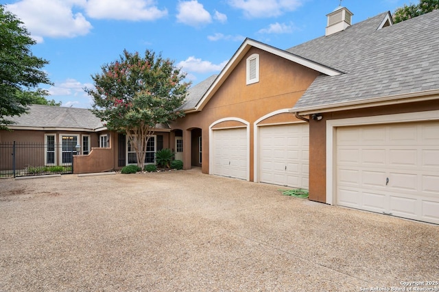 5 Remington, San Antonio, TX 78258 - traditional home featuring concrete driveway, roof with shingles, stucco siding, an attached garage, and a chimney