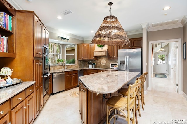 5 Remington, San Antonio, TX 78258 - kitchen with stainless steel appliances, custom exhaust hood, healthy amount of natural light, ornamental molding, and light stone countertops
