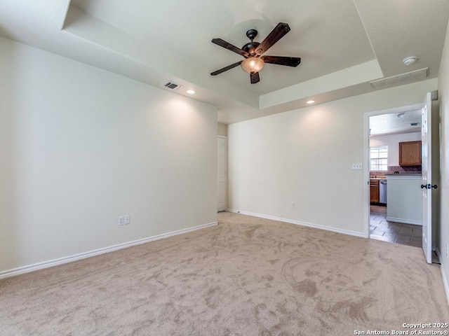97 Windcrest, Floresville, TX 78114 - unfurnished room featuring a tray ceiling, light colored carpet, ceiling fan, a smoke detector, and recessed lighting
