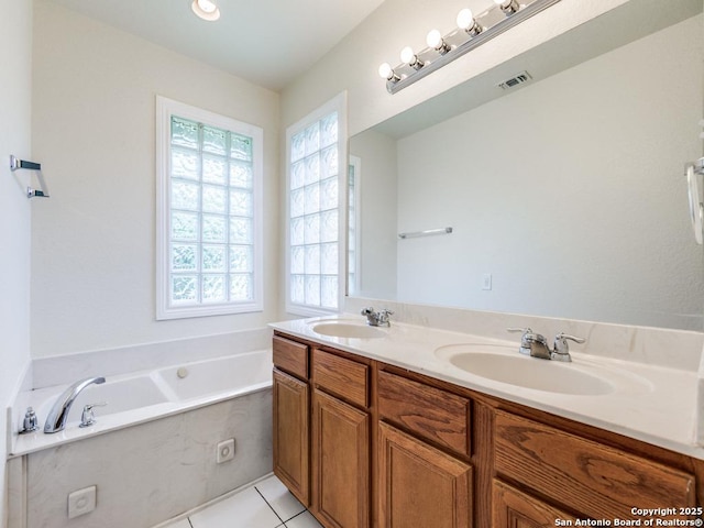 97 Windcrest, Floresville, TX 78114 - bathroom featuring a garden tub, double vanity, and tile patterned flooring