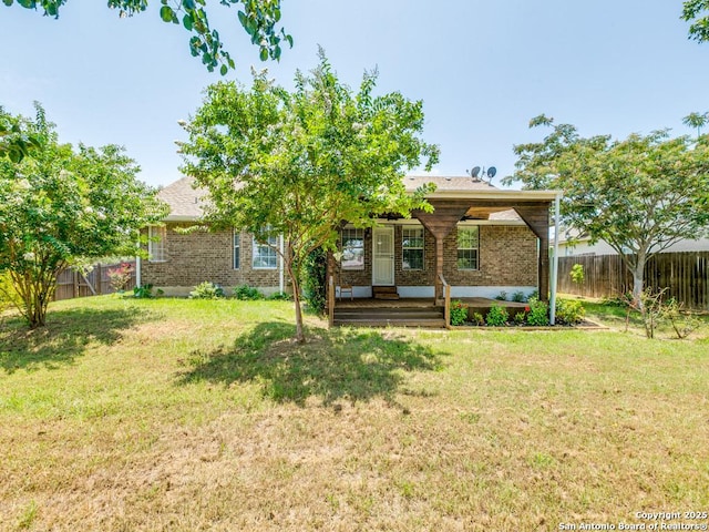 97 Windcrest, Floresville, TX 78114 - rear view of property featuring brick siding, a fenced backyard, and covered porch