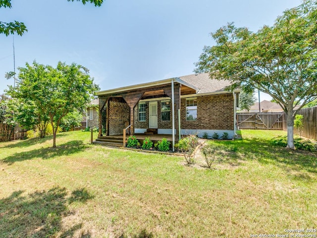 97 Windcrest, Floresville, TX 78114 - back of house featuring brick siding and a fenced backyard