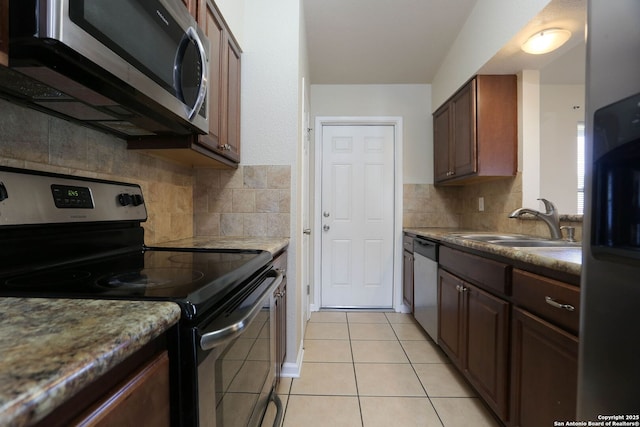 8226 Creekline Dr, San Antonio, TX 78251 - kitchen featuring appliances with stainless steel finishes, backsplash, light tile patterned flooring, and light countertops