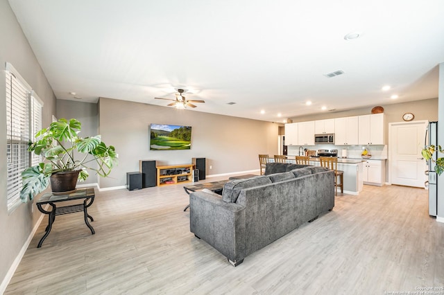 13215 Turnesa Ter, San Antonio, TX 78221 - living room with light wood-style flooring, a ceiling fan, and recessed lighting