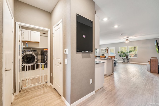 13215 Turnesa Ter, San Antonio, TX 78221 - corridor featuring light wood-style flooring, recessed lighting, a textured wall, and washer and clothes dryer