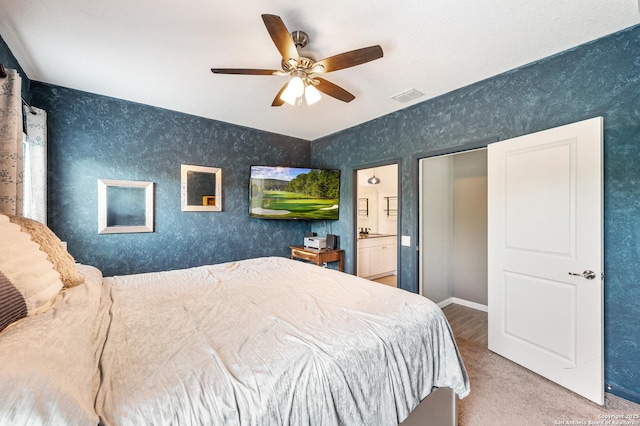 13215 Turnesa Ter, San Antonio, TX 78221 - carpeted bedroom featuring ceiling fan, ensuite bath, and wallpapered walls