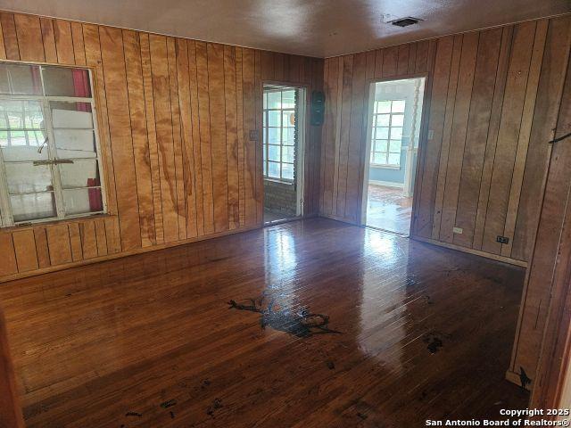 2310 W Gramercy, San Antonio, TX 78201 - unfurnished room featuring wood finished floors and wooden walls