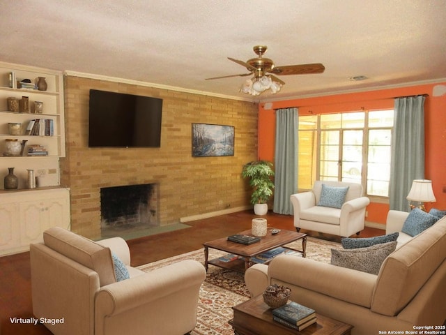 2310 W Gramercy, San Antonio, TX 78201 - living room featuring ceiling fan, wood finished floors, a brick fireplace, and crown molding